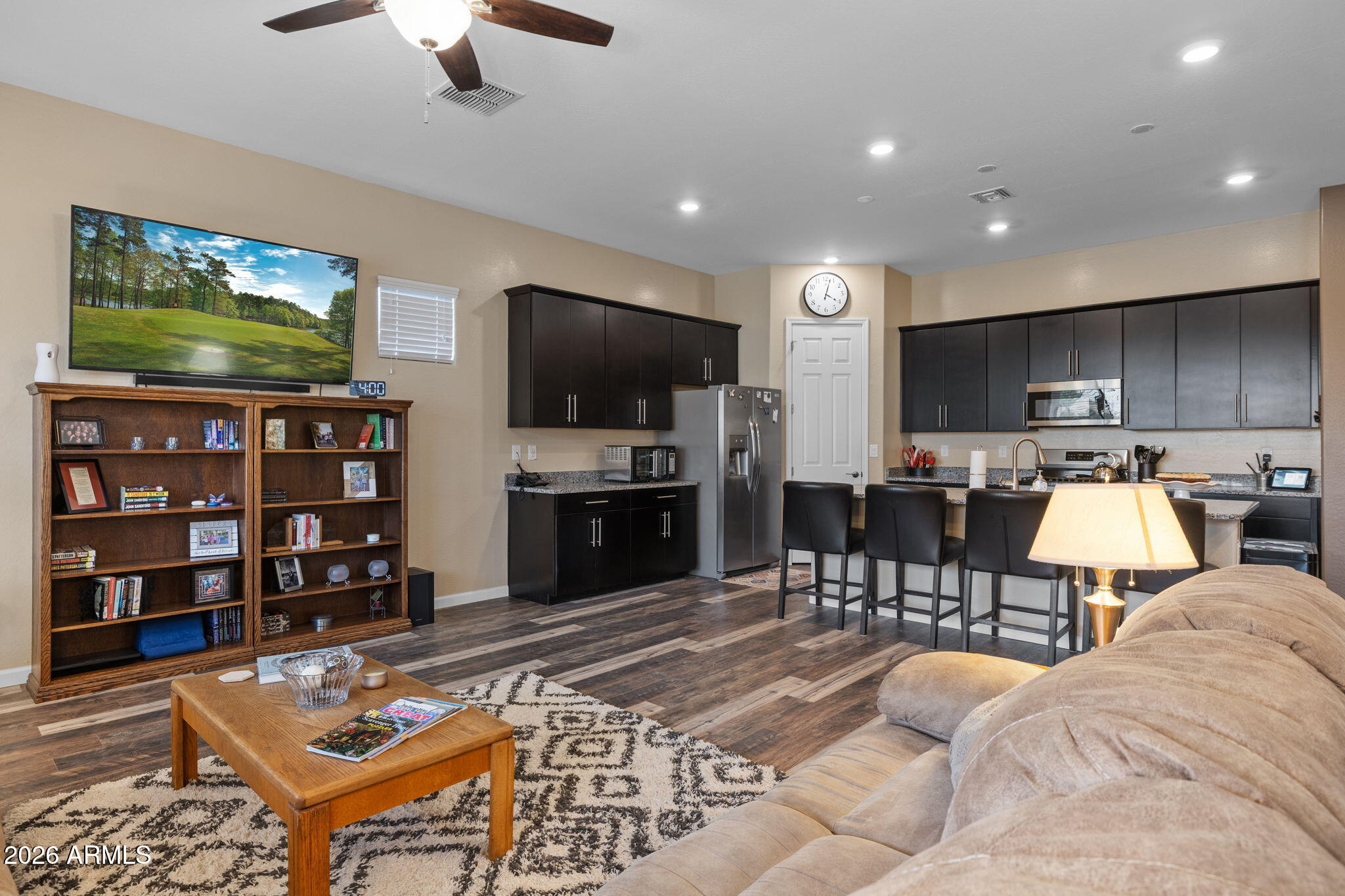 18502 West Desert Trumpet Road Goodyear, AZ 85338 - Photo 15 of 41 a living room with furniture a flat screen tv and kitchen view