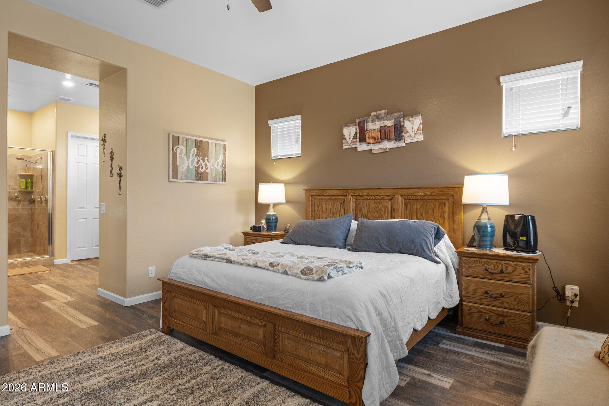 18502 West Desert Trumpet Road Goodyear, AZ 85338 - Photo 20 of 41 a bedroom with a bed and dresser with mirror