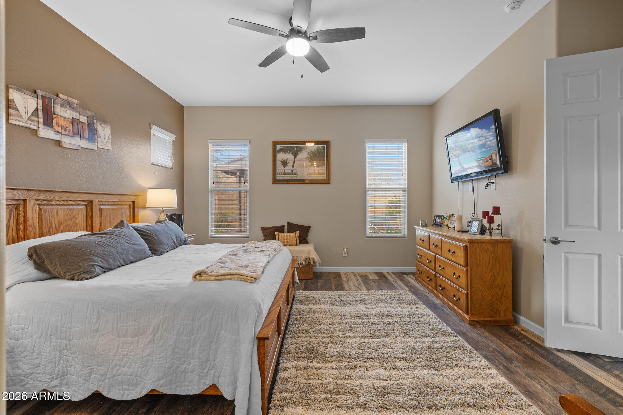 18502 West Desert Trumpet Road Goodyear, AZ 85338 - Photo 22 of 41 a bedroom with a bed and wooden floor