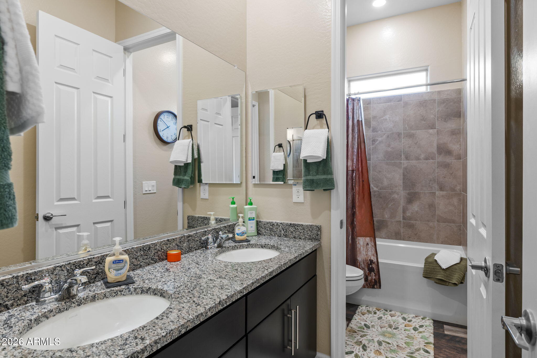 18502 West Desert Trumpet Road Goodyear, AZ 85338 - Photo 30 of 41 a bathroom with a granite countertop sink and a mirror