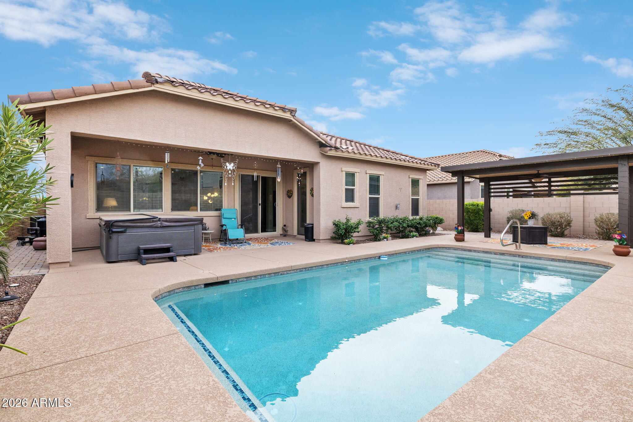 18502 West Desert Trumpet Road Goodyear, AZ 85338 - Photo 33 of 41 a view of a house with swimming pool and a porch with a sitting space