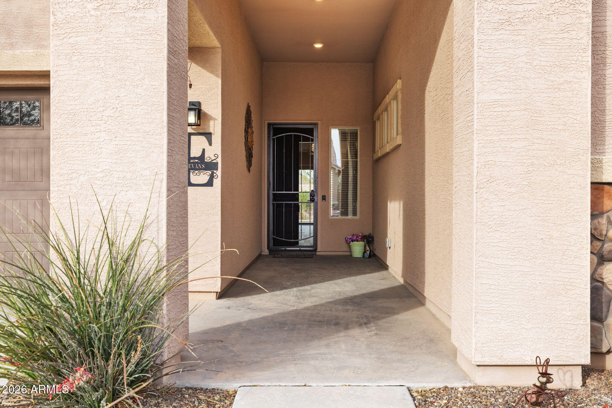 18502 West Desert Trumpet Road Goodyear, AZ 85338 - Photo 4 of 41 a view of a hallway with potted plants