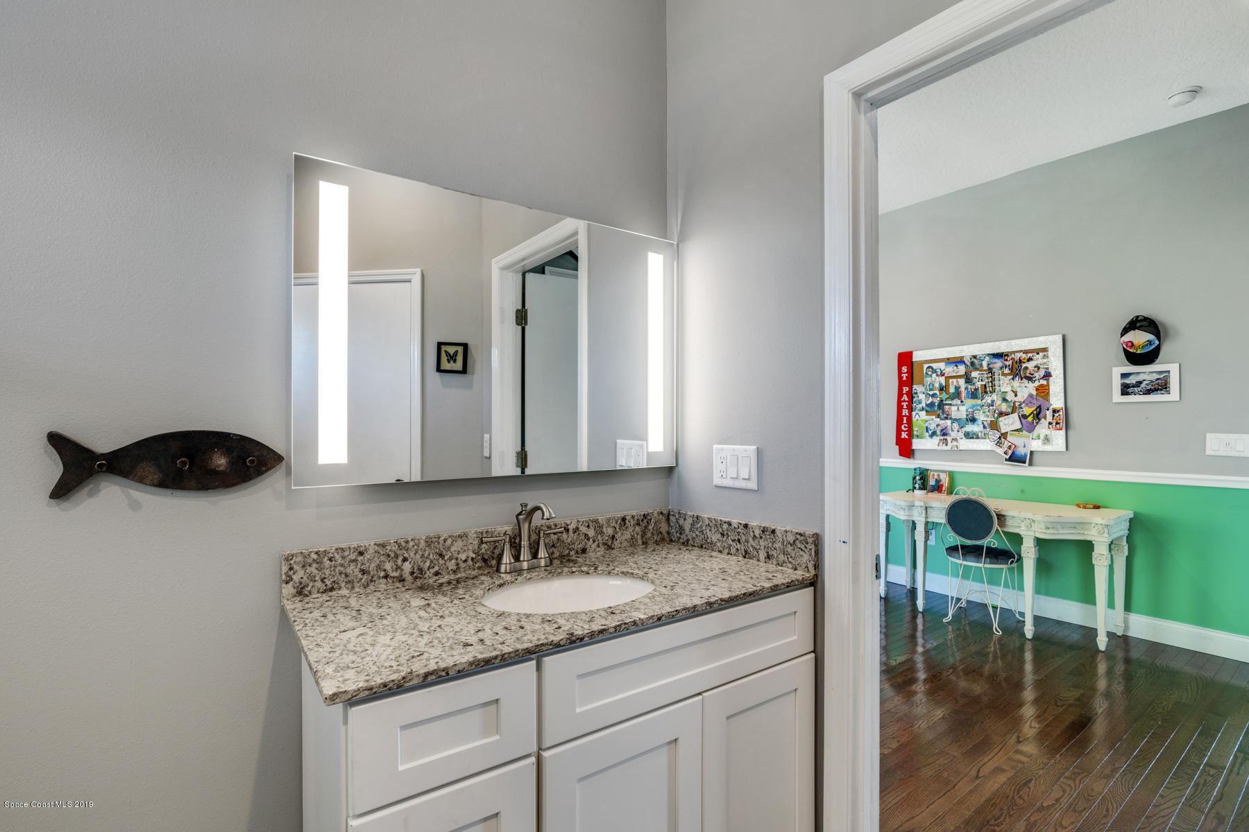 400 Richards Road Melbourne Beach, FL 32951 - Photo 41 of 59 a en suite bathroom with a granite countertop sink and a mirror