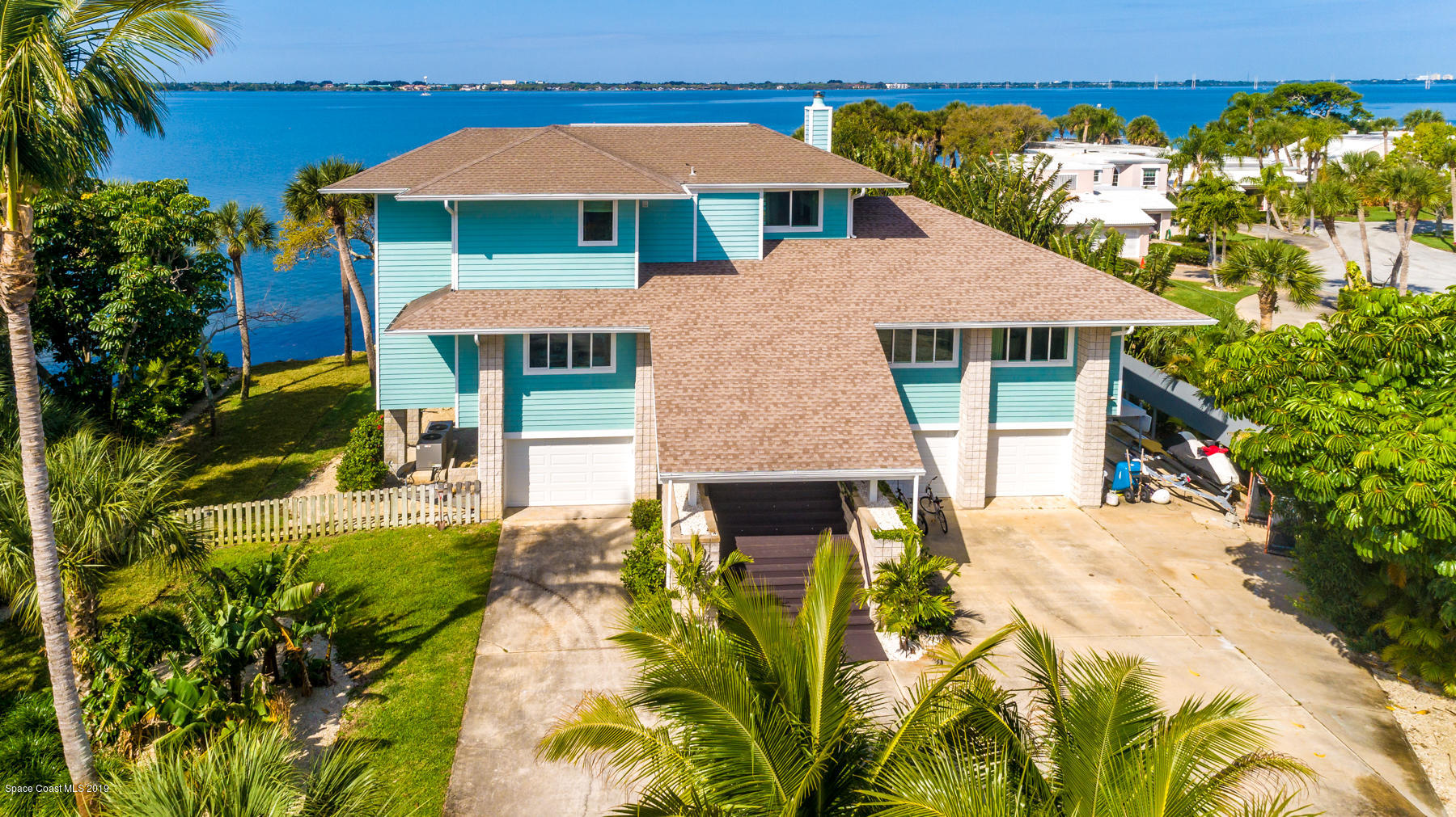 400 Richards Road Melbourne Beach, FL 32951 - Photo 7 of 59 a aerial view of a house with swimming pool lawn chairs under an umbrella