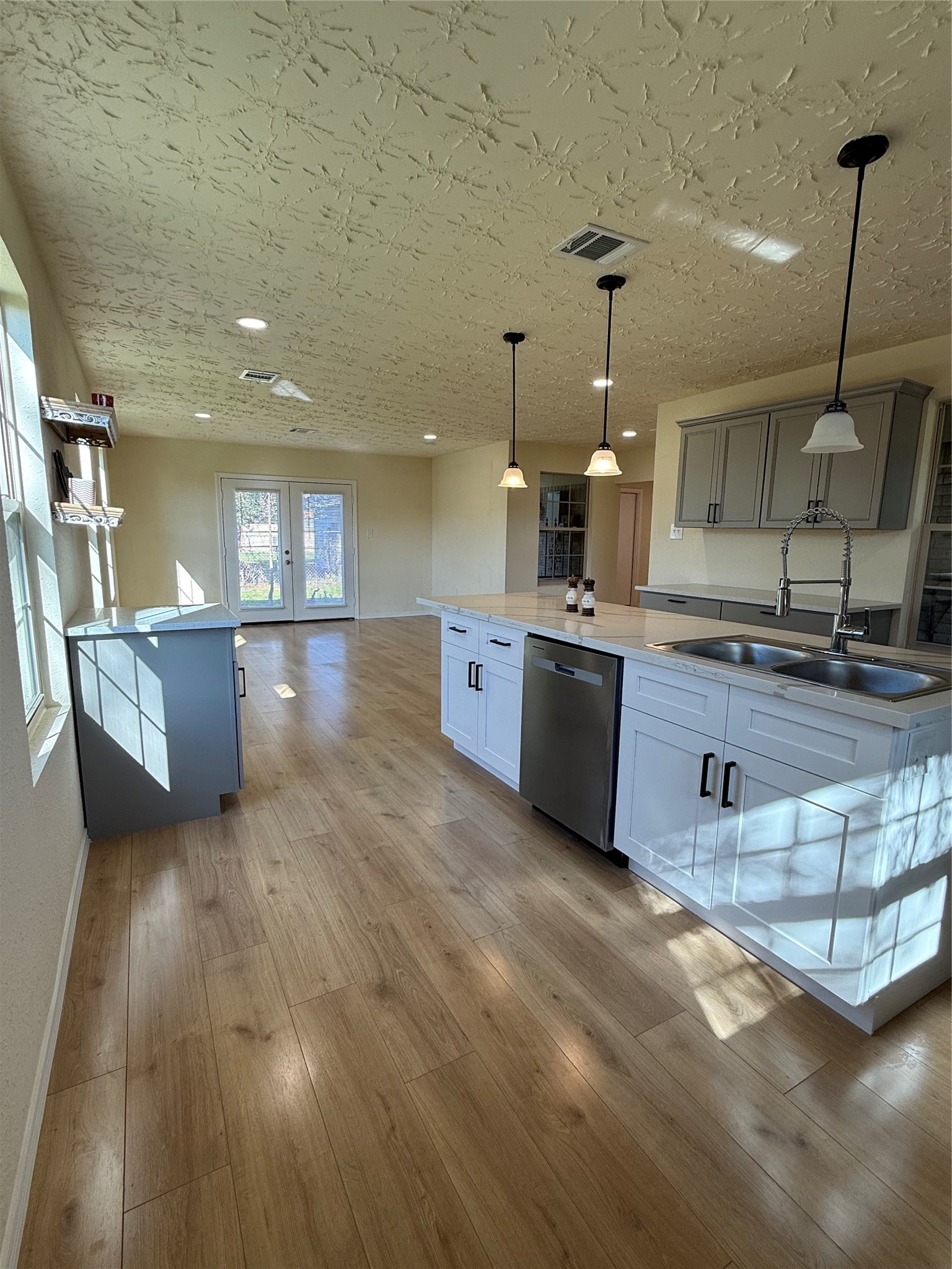 4546 Connorvale Road Houston, TX 77039 - Photo 11 of 25 a kitchen with stainless steel appliances granite countertop a sink dishwasher stove and wooden floors