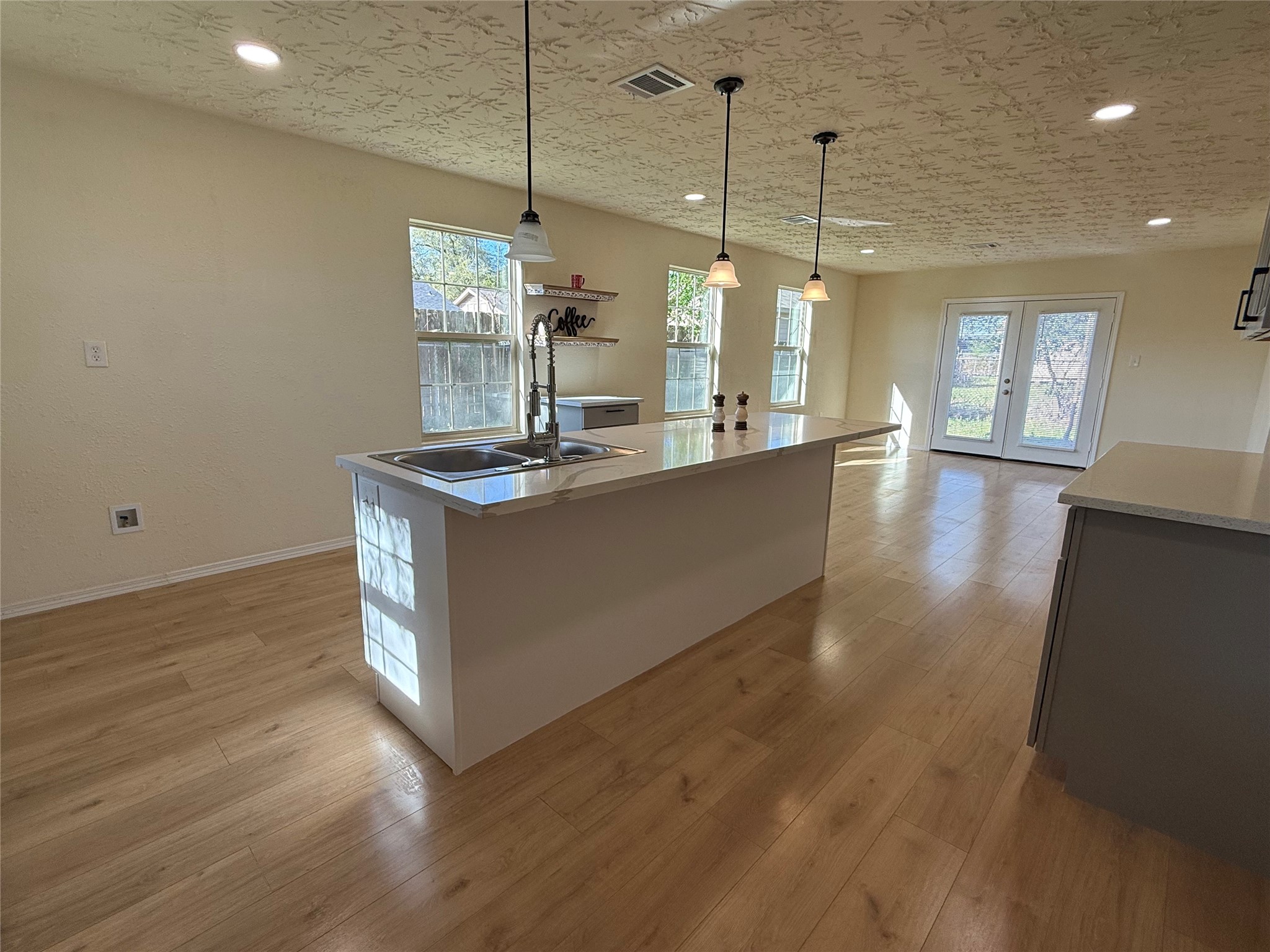 4546 Connorvale Road Houston, TX 77039 - Photo 12 of 25 a view of a kitchen island a chandelier and wooden floor