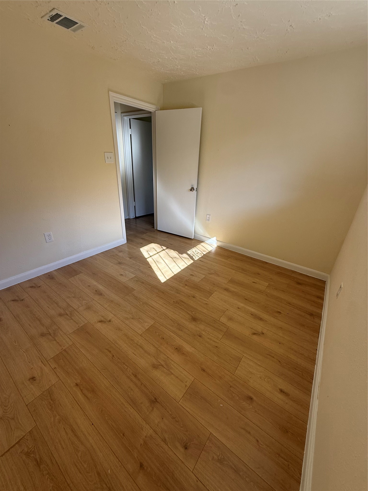 4546 Connorvale Road Houston, TX 77039 - Photo 19 of 25 a view of empty room with wooden floor