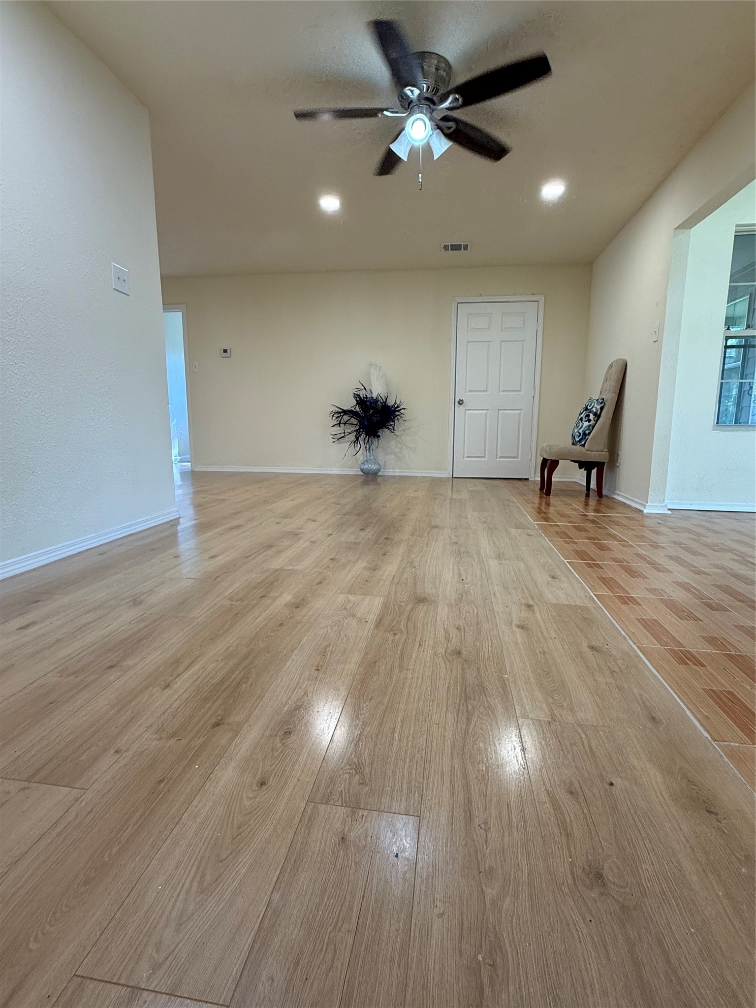 4546 Connorvale Road Houston, TX 77039 - Photo 6 of 25 a view of a livingroom with a hardwood floor and ceiling fan