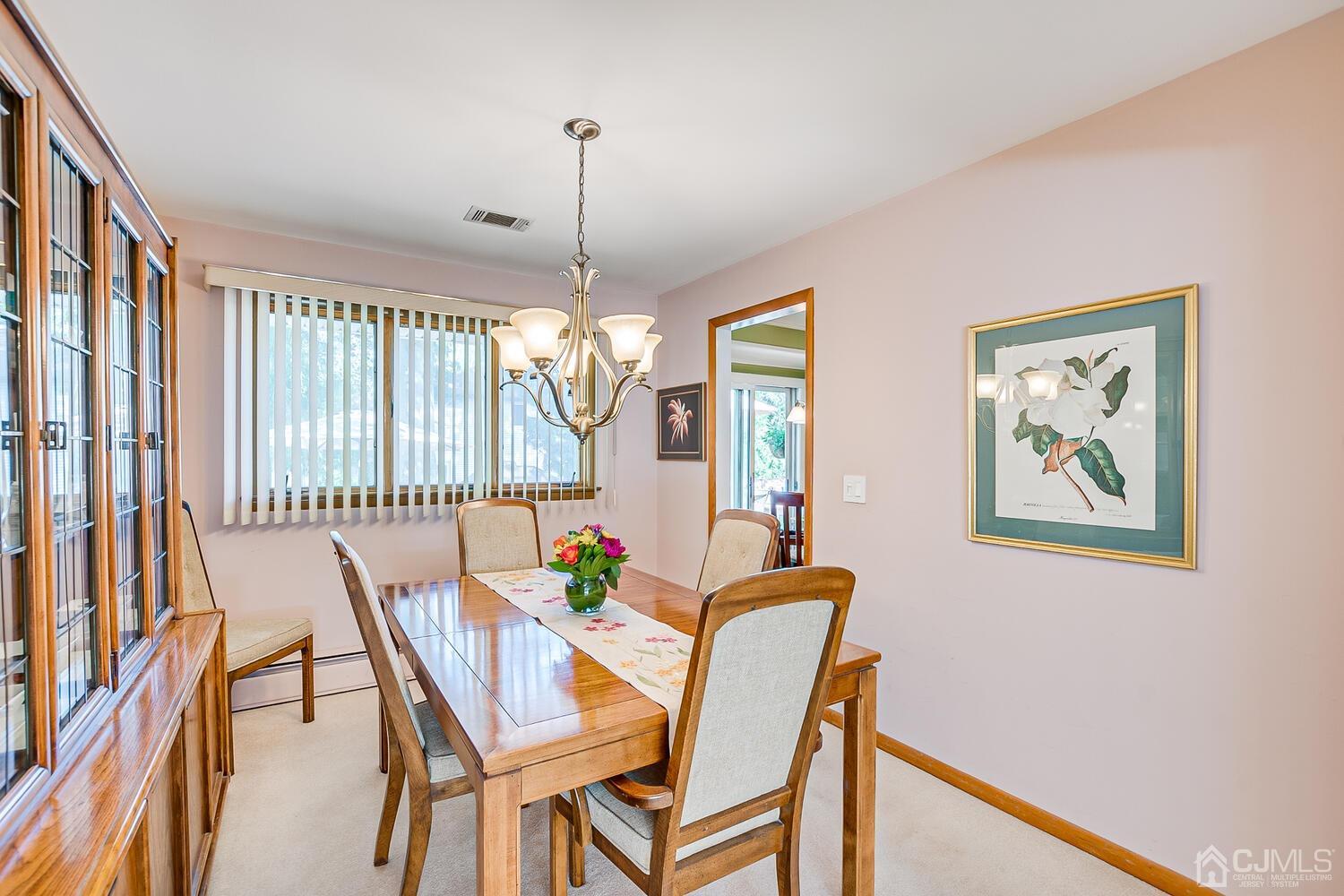 135 Floyd Street Edison, NJ 08820 - Photo 14 of 54 a view of a dining room with furniture window and wooden floor