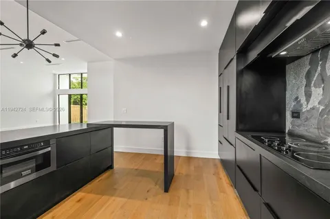 a kitchen with stainless steel appliances a stove microwave and sink