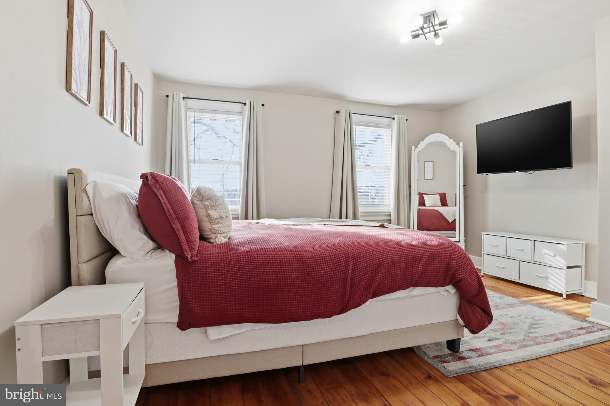 547 South Front Street Harrisburg, PA 17104 - Photo 16 of 33 a bedroom with a bed a flat screen tv and windows