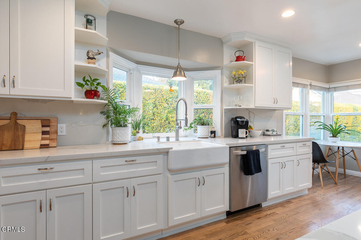 1404 Coolidge Avenue Pasadena, CA 91104 - Photo 12 of 33 a kitchen with cabinets appliances a sink and a window