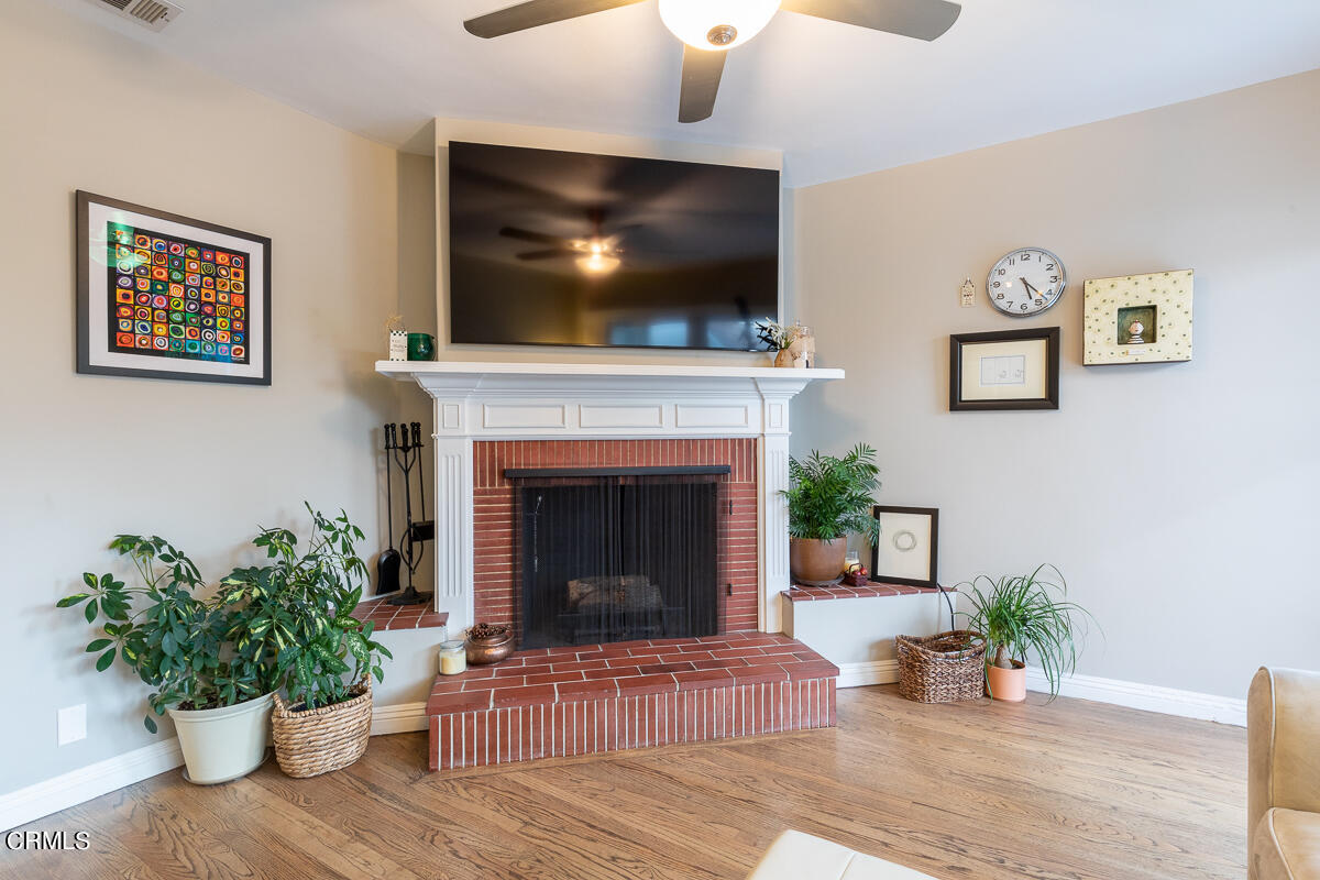 1404 Coolidge Avenue Pasadena, CA 91104 - Photo 19 of 33 a living room with furniture a flat screen tv and a fireplace