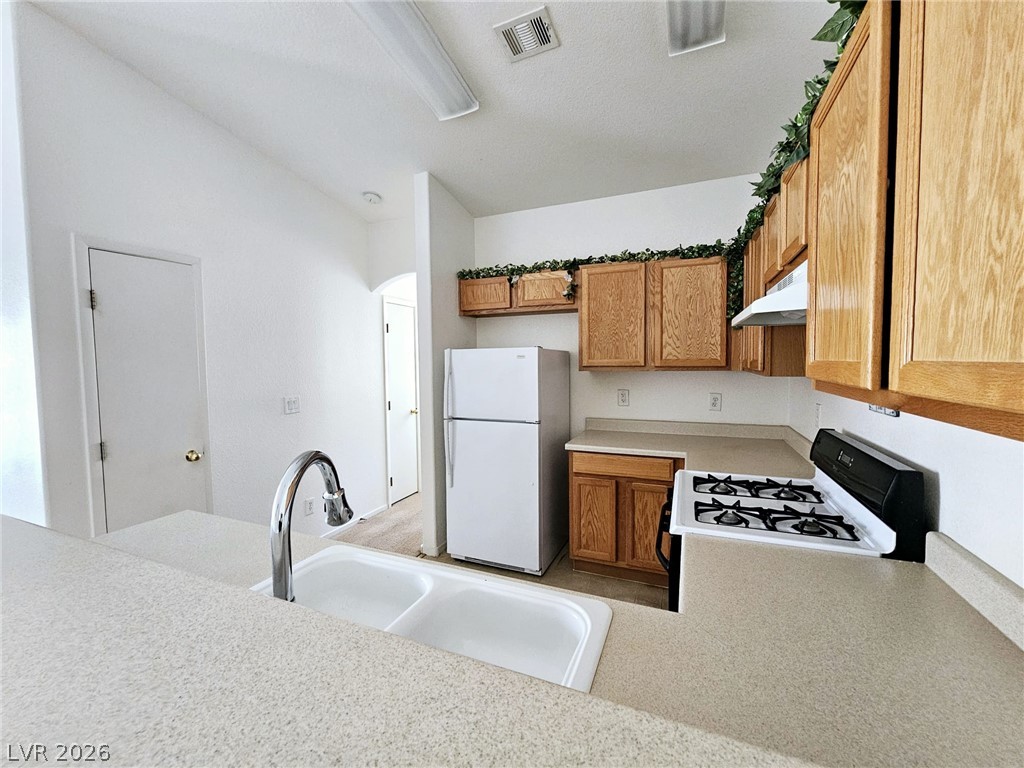 1663 Lefty Garcia Way Henderson, NV 89002 - Photo 9 of 31 A well-appointed kitchen offers ample counter space and classic cabinetry, ready for culinary endeavors.