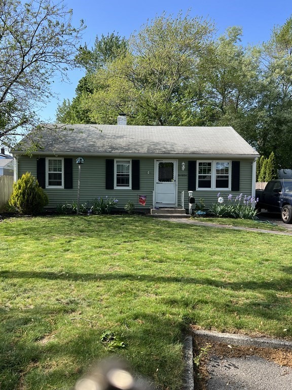 a front view of house with yard and green space