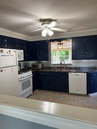21 Don Court Pawtucket, RI 02861 - Photo 3 of 16 a kitchen with granite countertop a refrigerator a sink dishwasher a stove and white cabinets with wooden floor