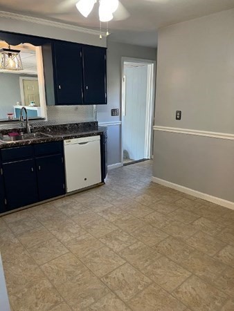 21 Don Court Pawtucket, RI 02861 - Photo 5 of 16 a kitchen with granite countertop a refrigerator and a stove top oven