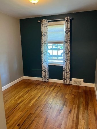 21 Don Court Pawtucket, RI 02861 - Photo 6 of 16 a view of empty room with wooden floor and fireplace