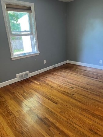 21 Don Court Pawtucket, RI 02861 - Photo 9 of 16 an empty room with wooden floor and windows