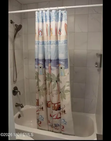 a bathroom with a bathtub and shower