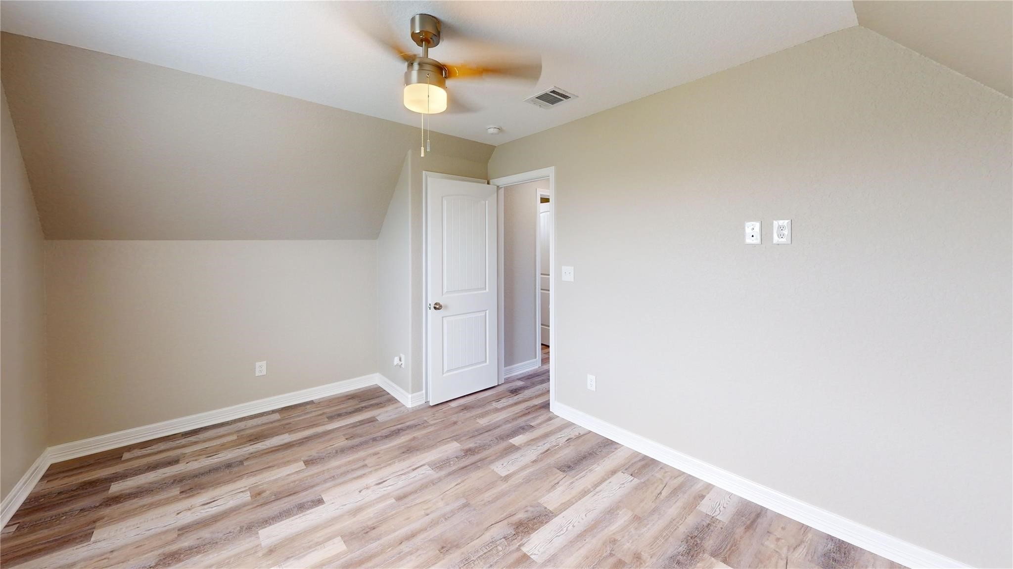 511 Caisson Street Surfside Beach, TX 77541 - Photo 19 of 33 a view of a room with wooden floor and a ceiling fan