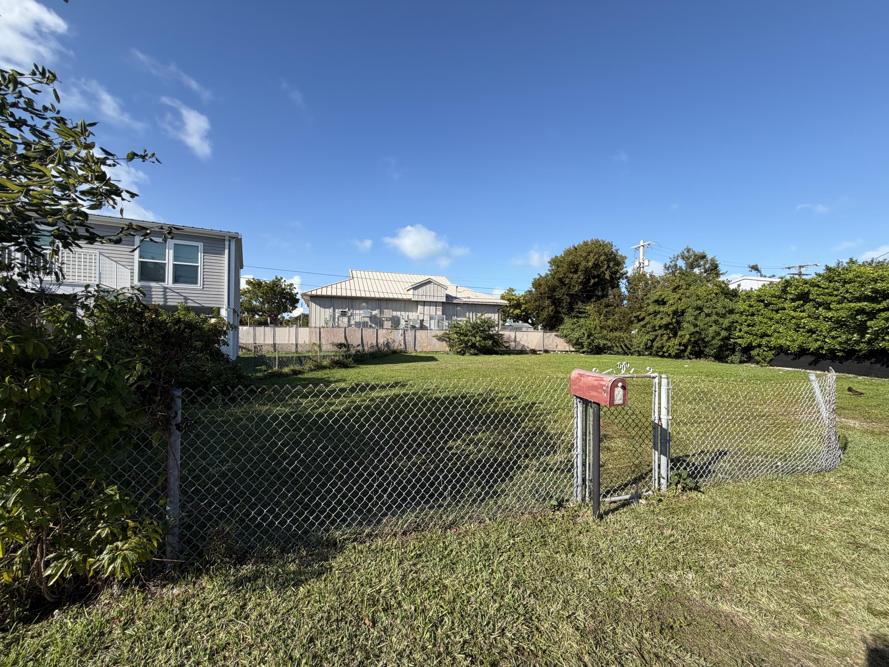 2 Dolphin Road Key West, FL 33040 - Photo 2 of 7 a garden view with a bench and trees in the background