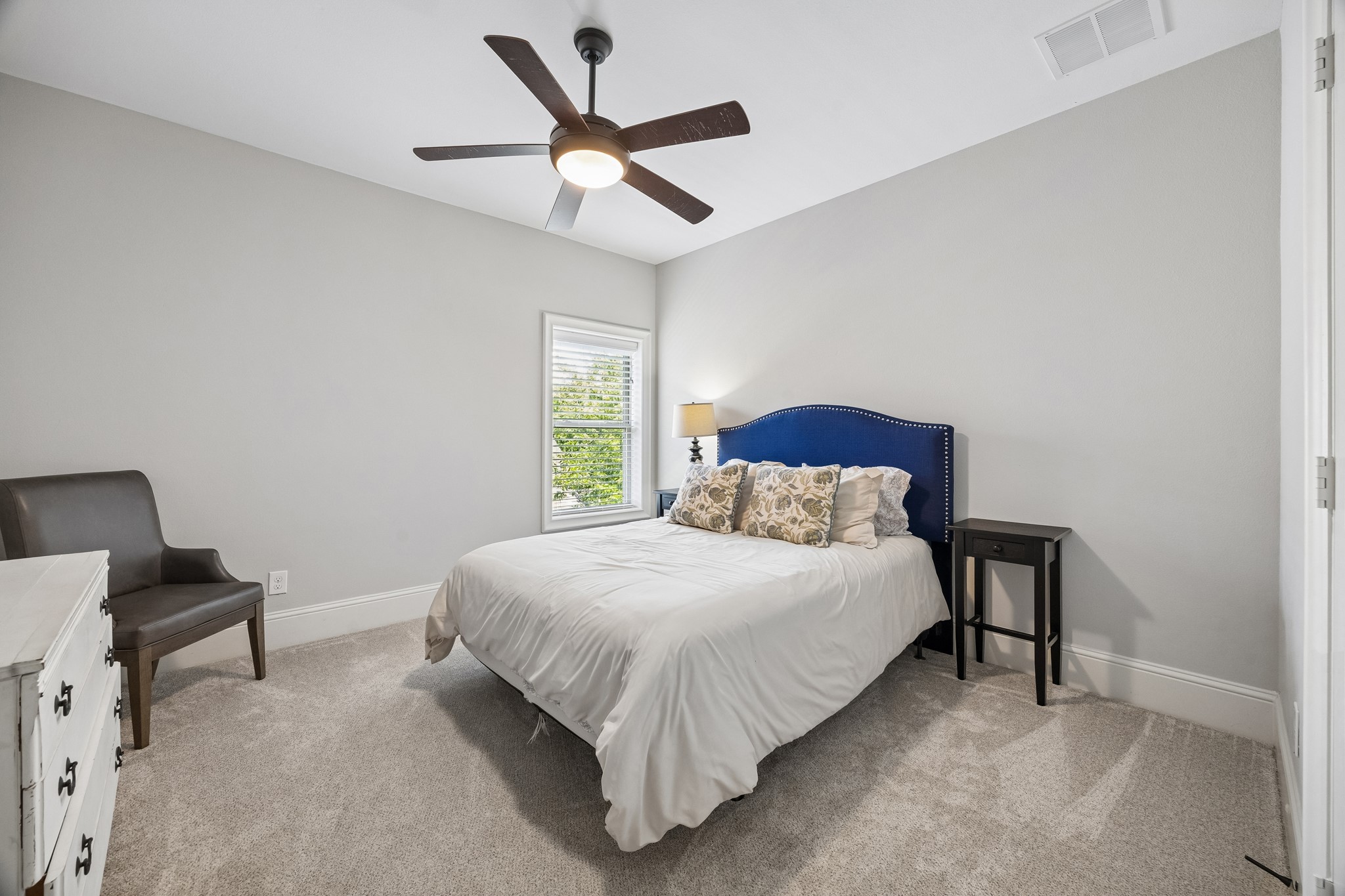 1360 Chippendale Road Houston, TX 77018 - Photo 21 of 34 Comfortable secondary bedroom #1 conveniently located just off the game room featuring a large window, ceiling fan, walk-in closet, and neutral finishes. Well-suited for family members or guests while offering easy access to the nearby hall bath.