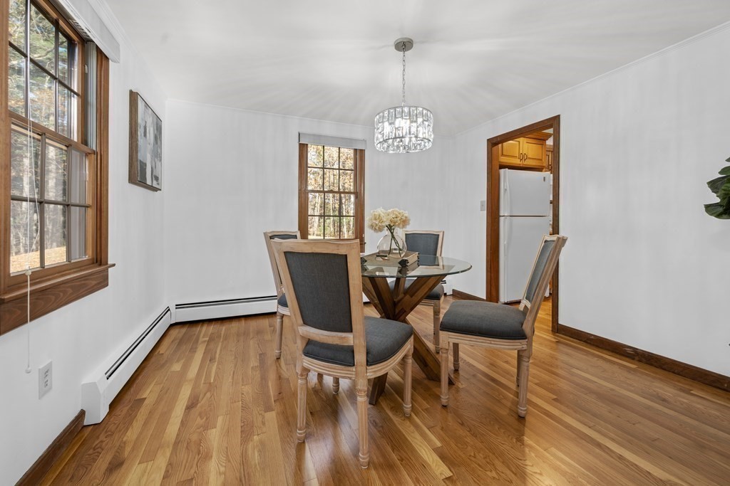 89 Ipswich Road Boxford, MA 01921 - Photo 5 of 18 a view of a dining room with furniture a chandelier and wooden floor