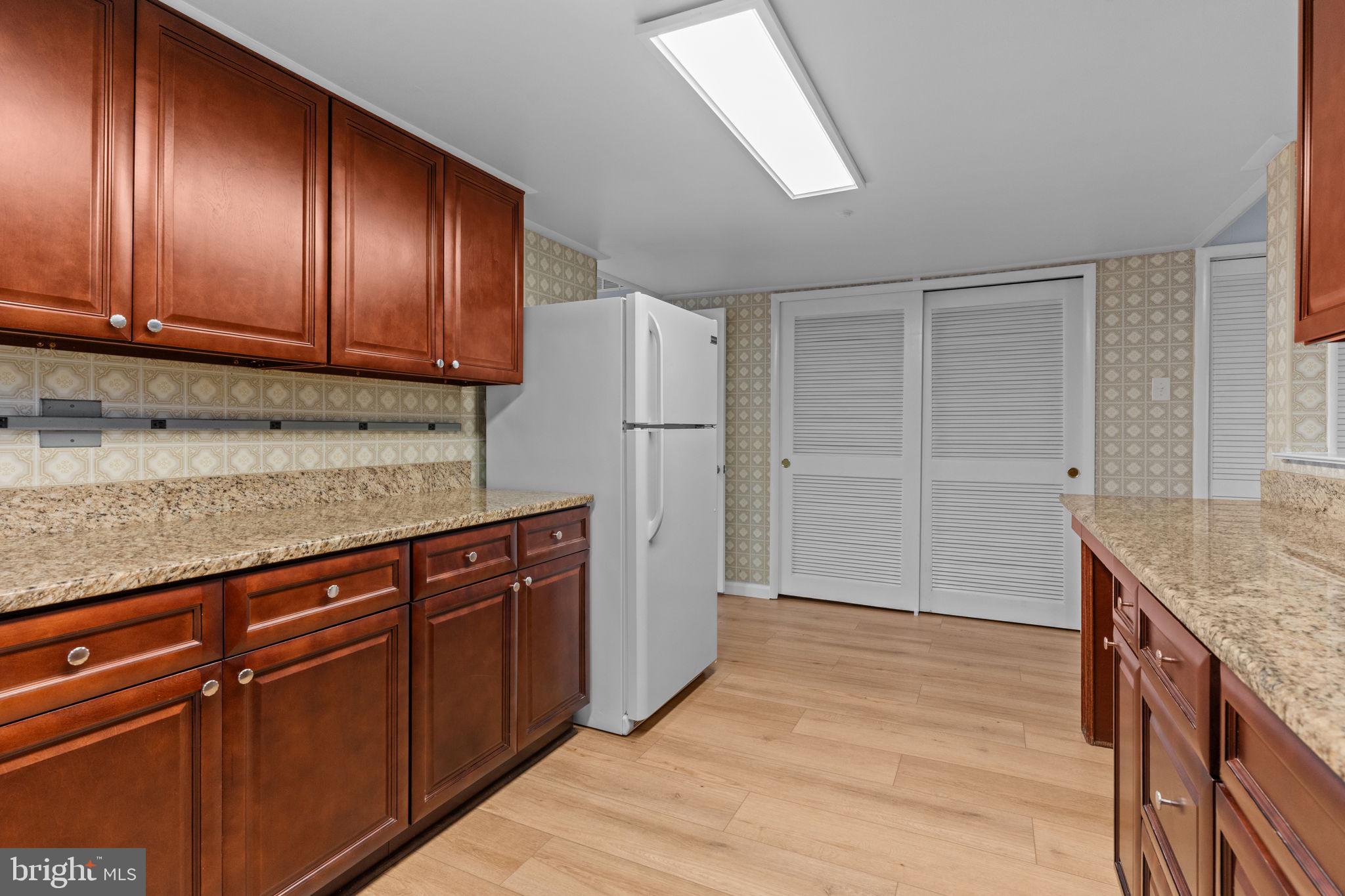 9823 Bonner Street Philadelphia, PA 19115 - Photo 11 of 29 a kitchen with stainless steel appliances granite countertop wooden cabinets and granite counter tops