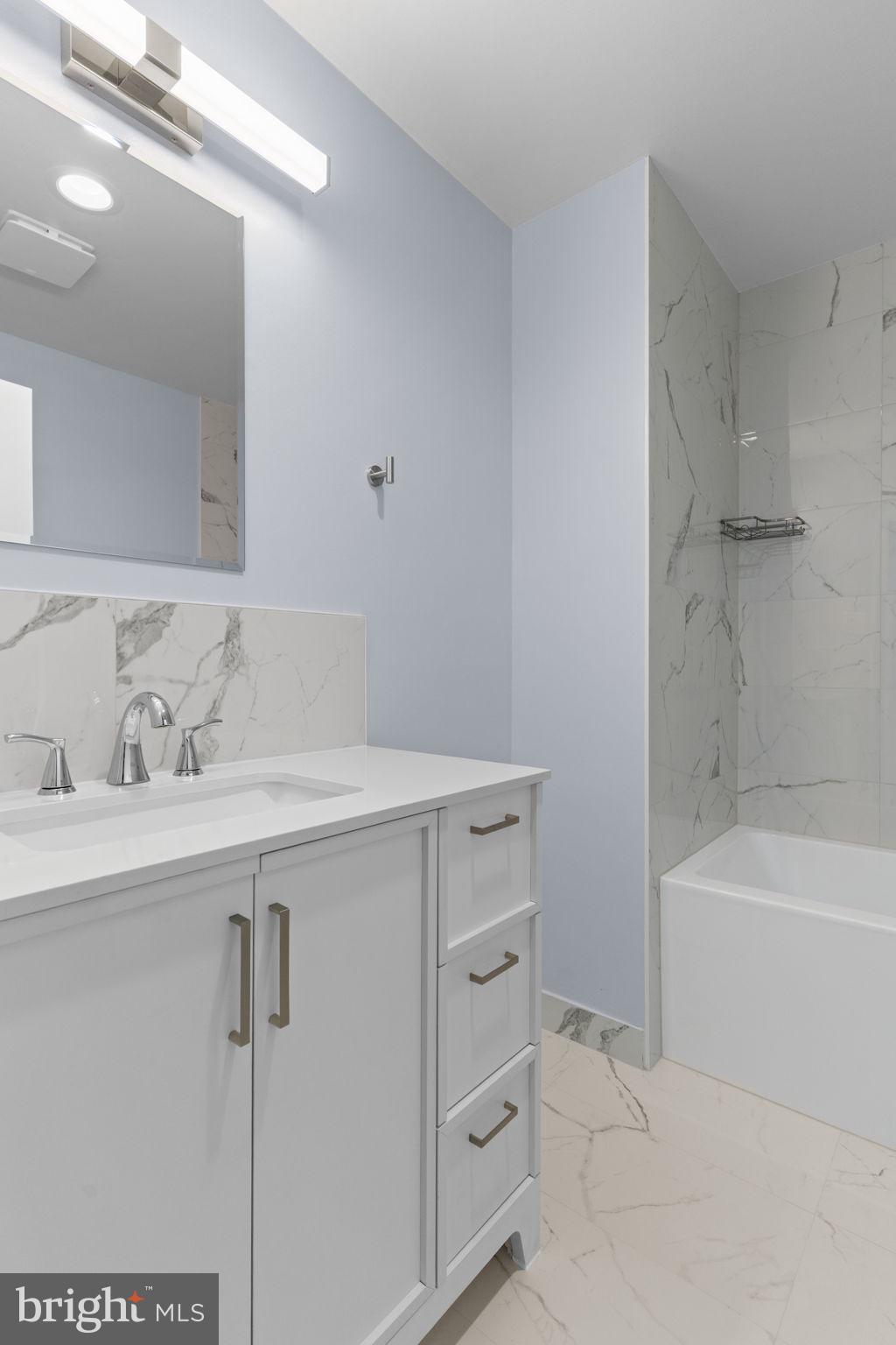 9823 Bonner Street Philadelphia, PA 19115 - Photo 22 of 29 a bathroom with a sink a toilet and bathtub