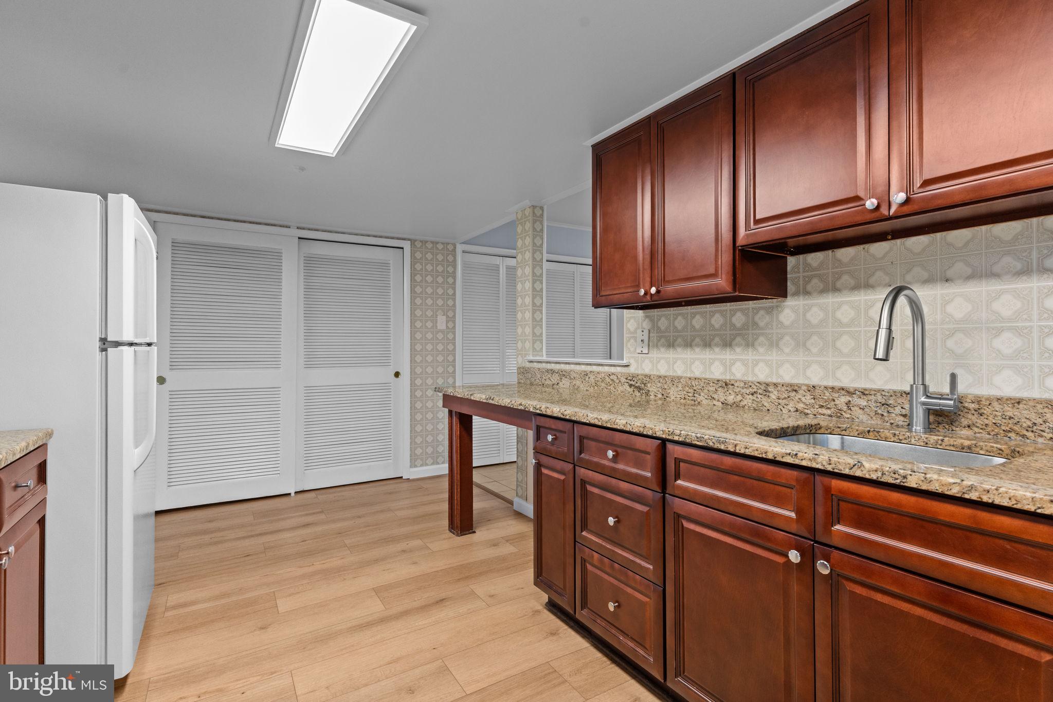 9823 Bonner Street Philadelphia, PA 19115 - Photo 10 of 29 a kitchen with stainless steel appliances granite countertop wooden cabinets and a sink