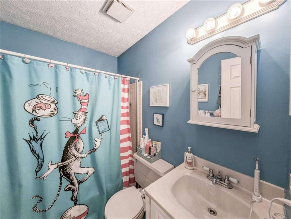 3838 Hunting Ridge Drive Southwest Lilburn, GA 30047 - Photo 38 of 56 a bathroom with a sink mirror vanity and toilet