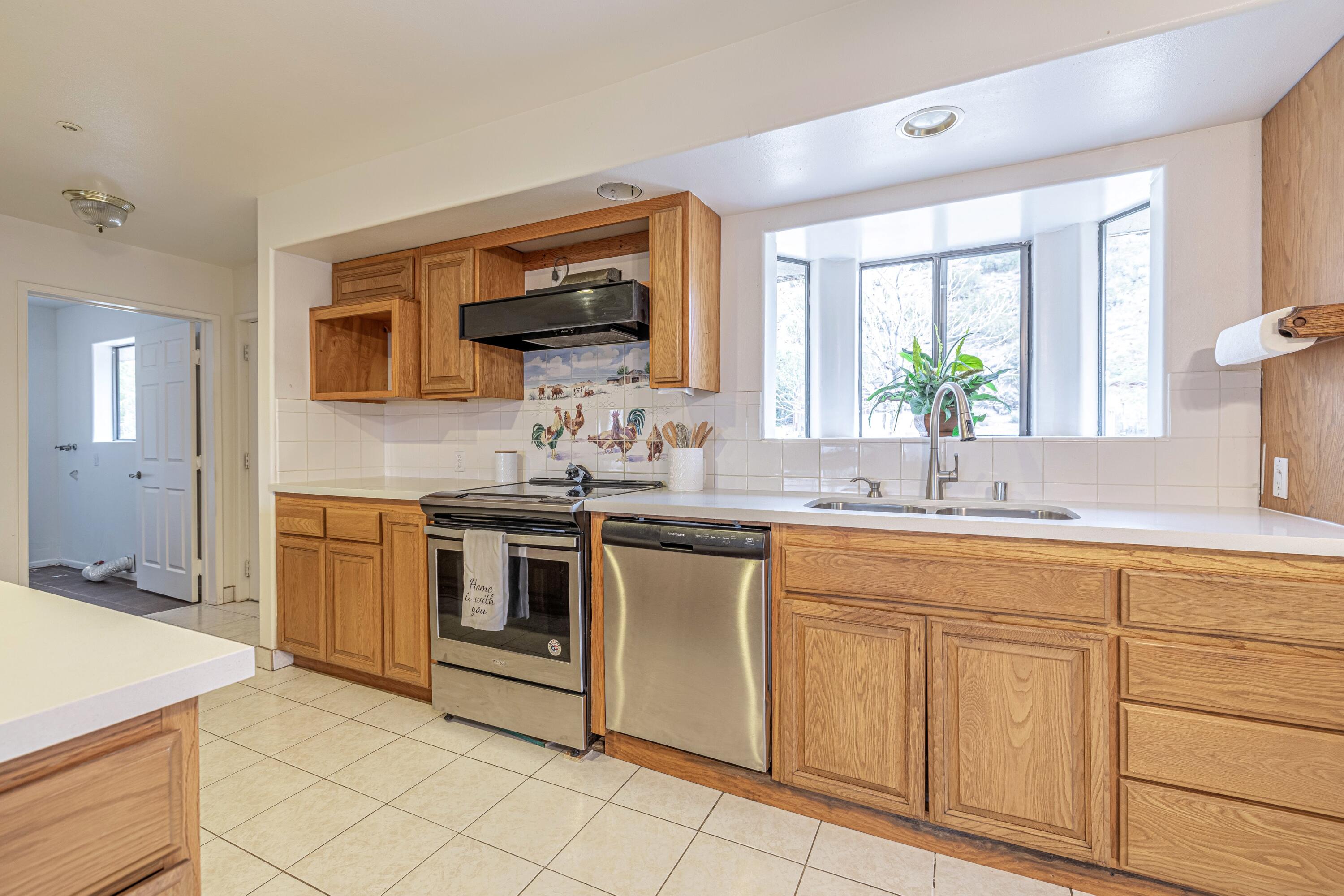 17118 Bob's Gap Road Valyermo, CA 93563 - Photo 15 of 55 a kitchen with stainless steel appliances granite countertop a sink and stove