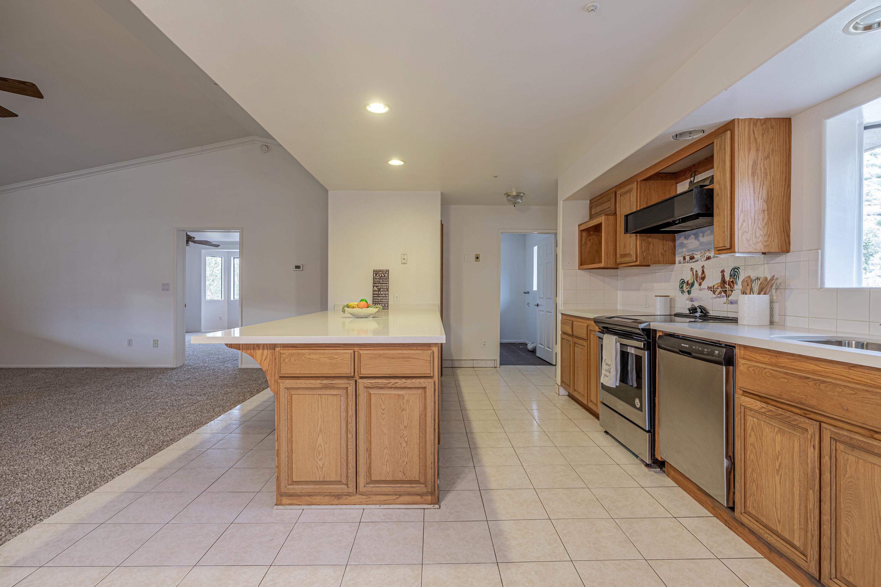 17118 Bob's Gap Road Valyermo, CA 93563 - Photo 16 of 55 a large kitchen with stainless steel appliances a sink and cabinets