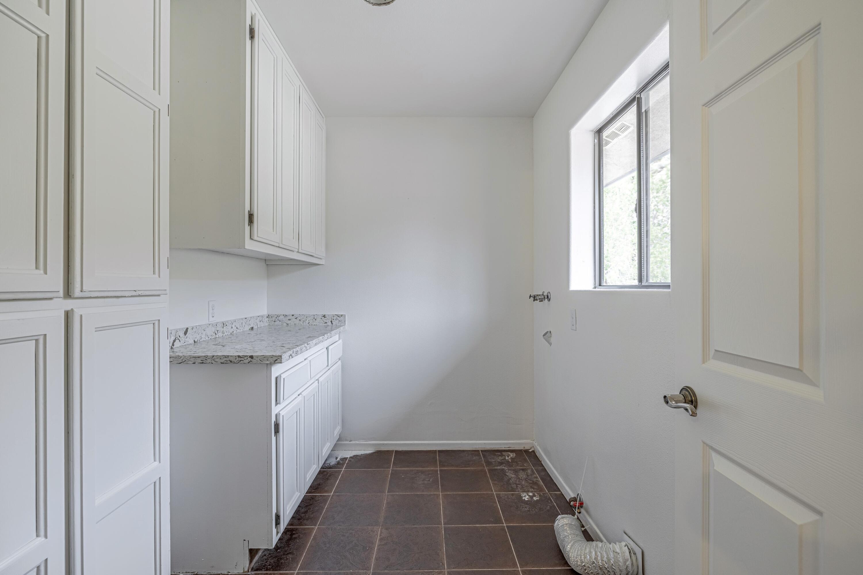17118 Bob's Gap Road Valyermo, CA 93563 - Photo 20 of 55 a hallway with washer and dryer