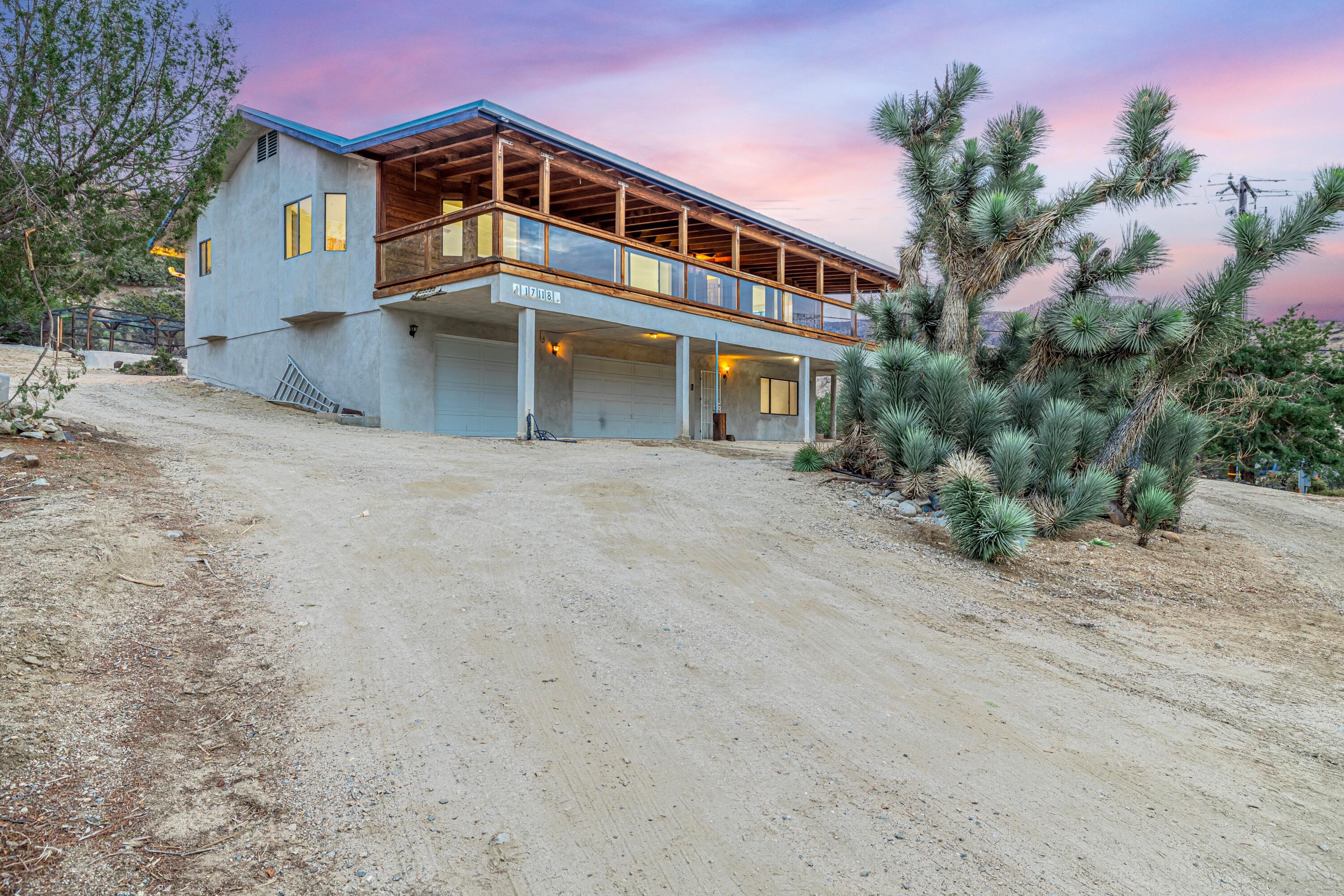 17118 Bob's Gap Road Valyermo, CA 93563 - Photo 42 of 55 a front view of a house with a yard and garage