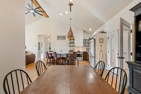 a view of a a dining room with furniture window and wooden floor
