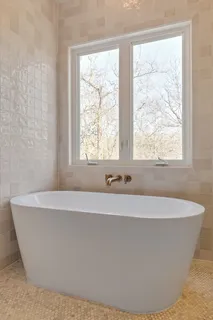 a white bath tub sitting in a bathroom