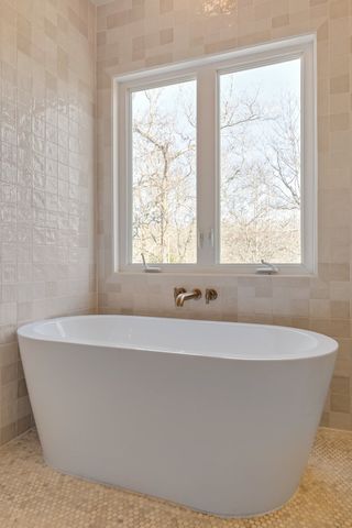 a white bath tub sitting in a bathroom