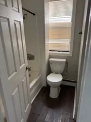 a bathroom with a toilet and a shower