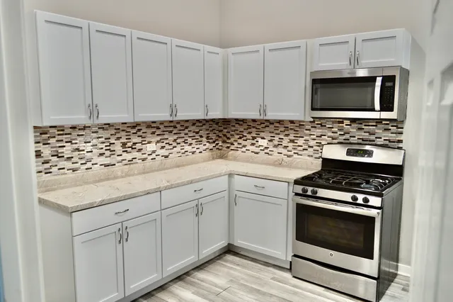 a kitchen with a refrigerator stove and microwave