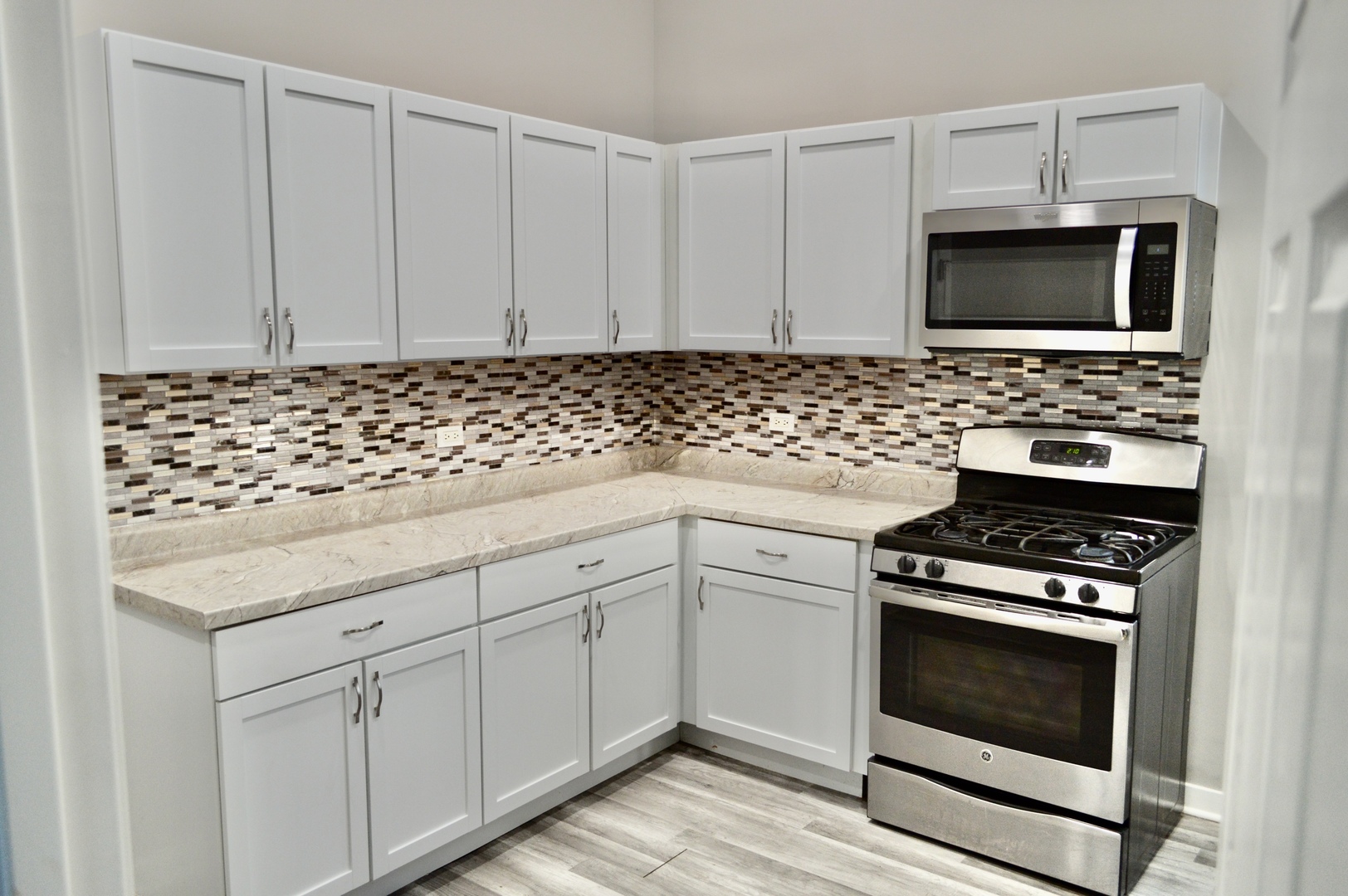 522 West 81st Street, Unit 1 Chicago, IL 60620 - Photo 3 of 9 a kitchen with white cabinets and appliances