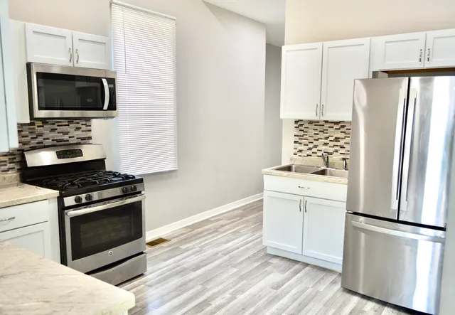 a bathroom with a sink mirror vanity and toilet