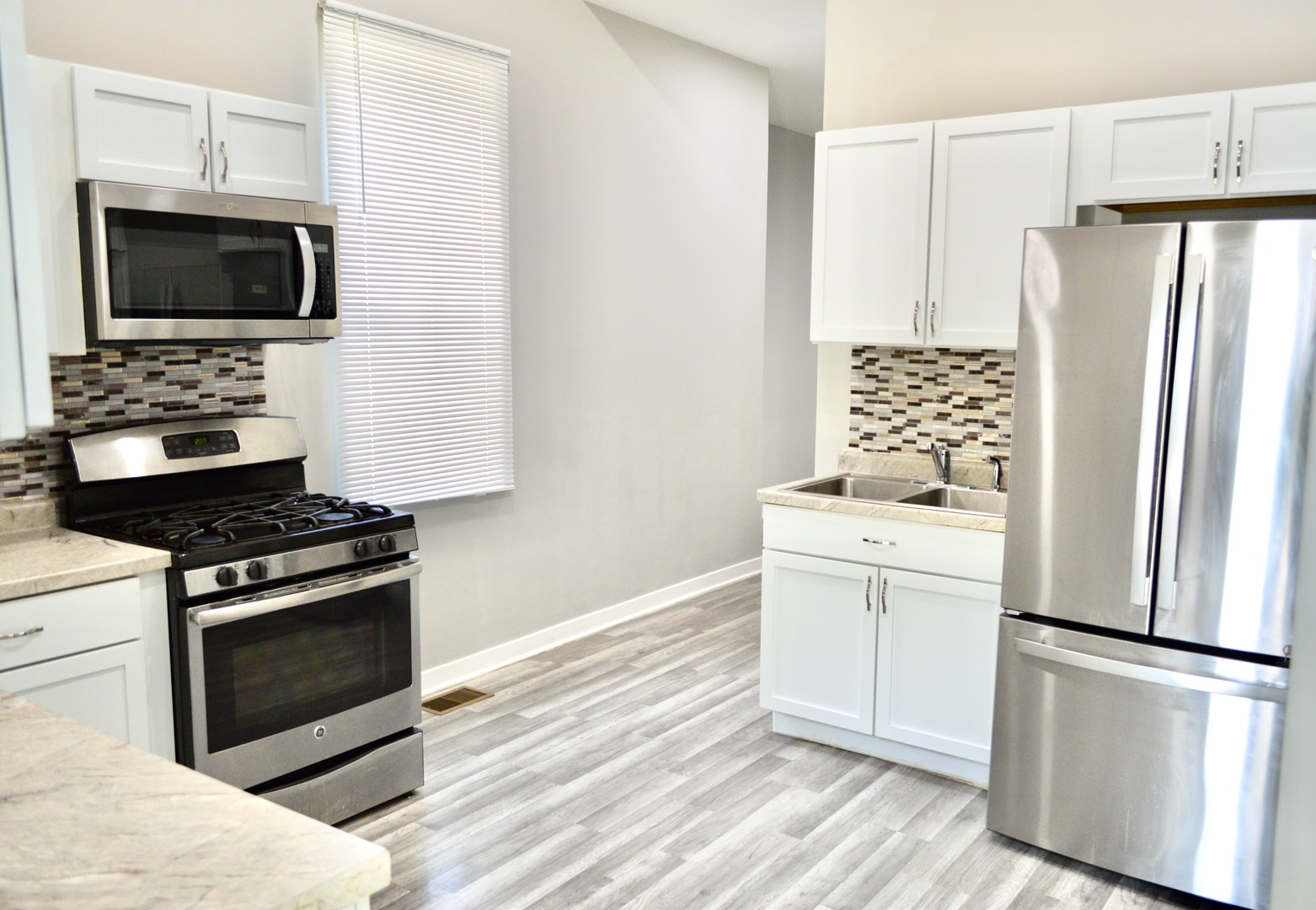 522 West 81st Street, Unit 1 Chicago, IL 60620 - Photo 4 of 9 a kitchen with a refrigerator stove and microwave
