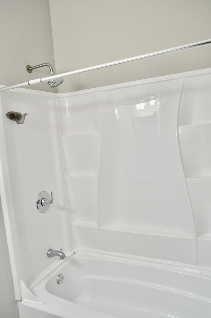 522 West 81st Street, Unit 1 Chicago, IL 60620 - Photo 6 of 9 a bathroom with a shower and a bath tub