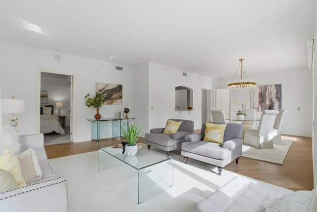a living room with furniture and a chandelier