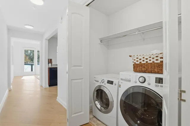 a view of a hallway with washer and dryer