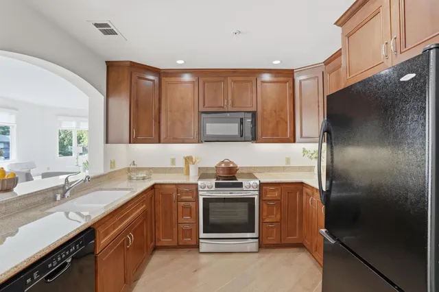 a kitchen with a sink and a refrigerator