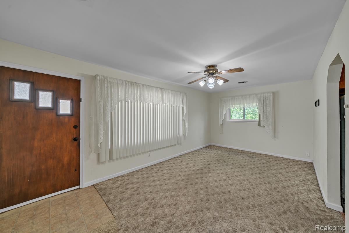 8620 Stephens Road Warren, MI 48089 - Photo 10 of 15 Entryway with ceiling fan and light carpet