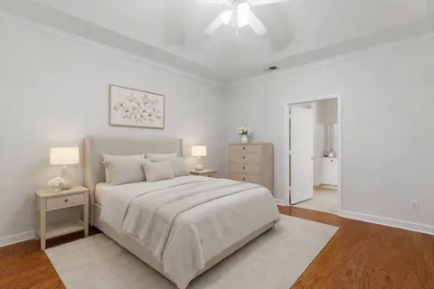 a bedroom with a bed and a chandelier